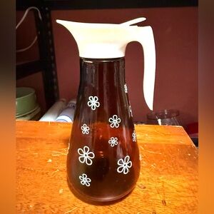 A vintage MCM Thatcher Glass or Anchor Hocking amber glass syrup dispenser